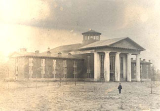 A view of the original Chambers Building with a person in the foreground
