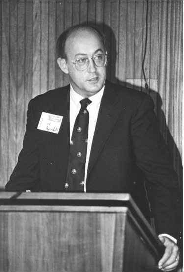 President John Kuykendall delivering a speech from behind a podium.