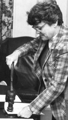 Assistant Dean Sue Ross stamping documents for approval, 1985.