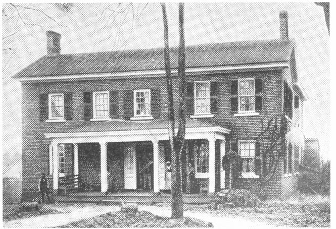 The president's house pictured from the front in 1894. A black woman can be seen on the front porch.