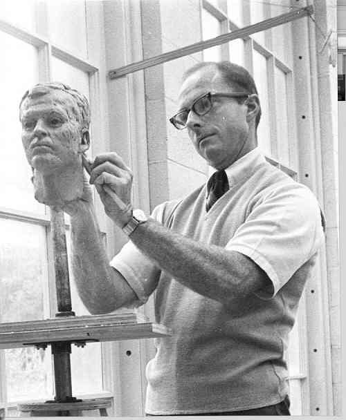 Tom Clark carving a clay head