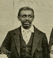 Joe, an older black man dressed formally in a jacket and tie