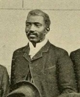 Jack, a black man dressed formally in a jacket and tie