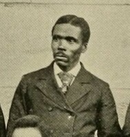 Lewis, a black man dressed formally in a jacket and tie