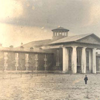 A view of the original Chambers Building with a person in the foreground

