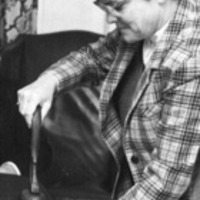 Assistant Dean Sue Ross stamping documents for approval, 1985.