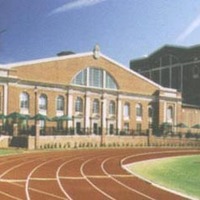 A view of the Knobloch Campus Center from the Belk-Irwin track within Richardson Stadium. The fascade of the main structure is the old Johnston Gym. The large struction to the left is the Duke Family Performance Hall.