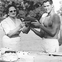 Mrs. Whittle holding cake with Robert Dean, 1963 winner.