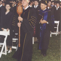 Dr. Leland Park holds the college mace