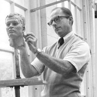 Tom Clark carving a clay head